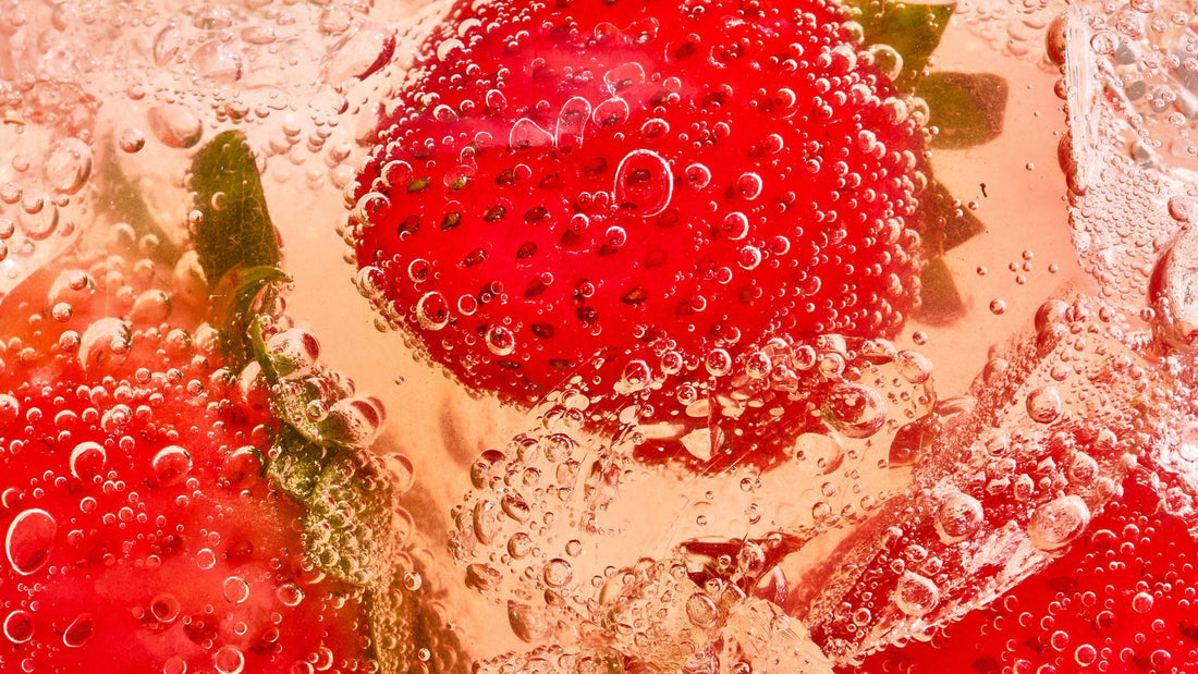 macro close up shot of strawberries in bubbly liquid