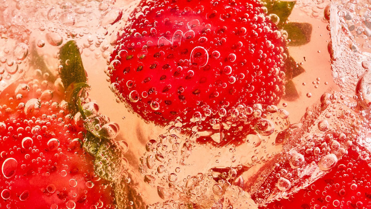 macro close up shot of strawberries in bubbly liquid